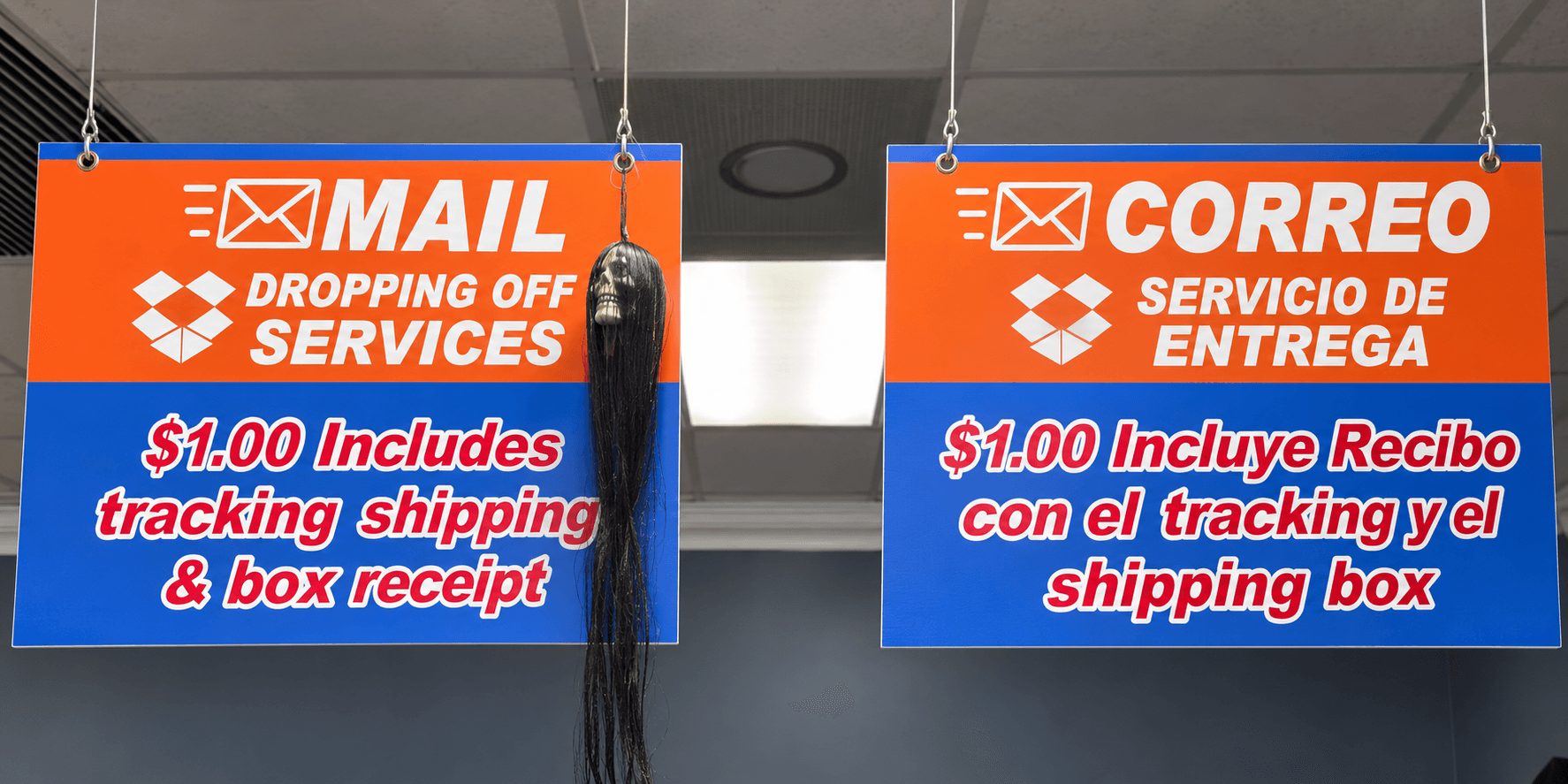 AI-enhanced close-up of the original English and Spanish store signs displaying the $1.00 mail drop-off service, tracking and receipt notice.